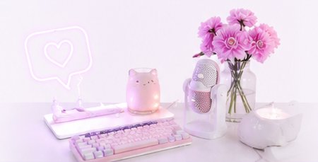 Soft pastel craft corner with pink flowers for a cozy cross-stitch stream