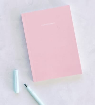 Pink notebook and pastel pen, ready for a note to contact JustLilyGrace