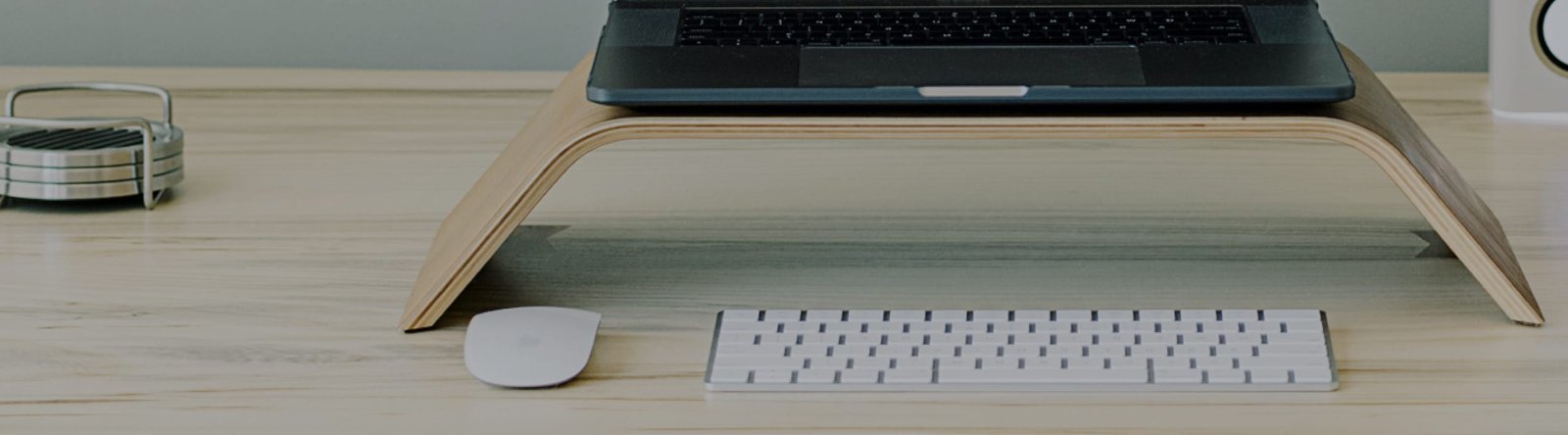 Tidy desk with a laptop on a stand, ready for a focused co-working session